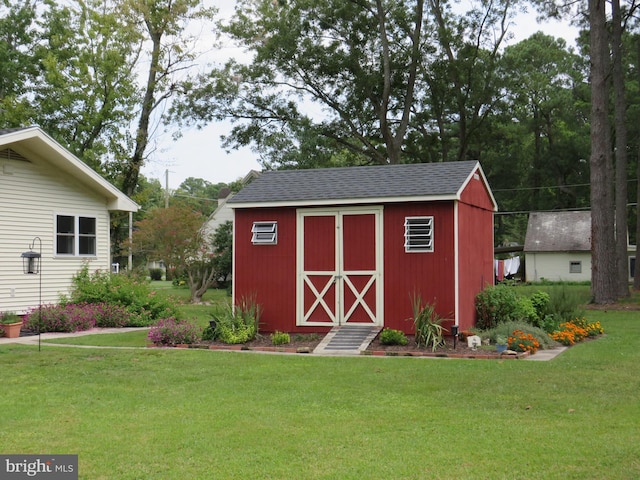 view of outbuilding with a lawn