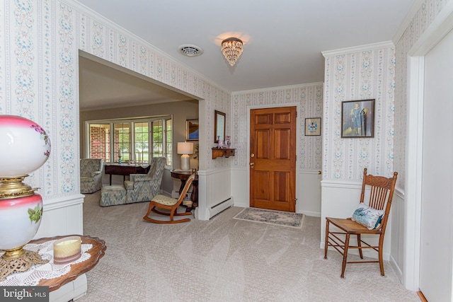 carpeted entryway with ornamental molding and a baseboard radiator