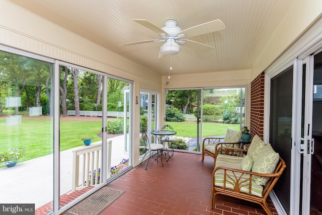 sunroom featuring ceiling fan and plenty of natural light