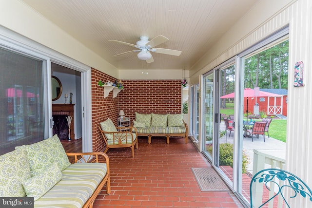 sunroom featuring ceiling fan