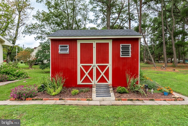 view of outbuilding with a lawn