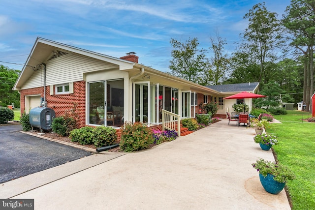 exterior space with a yard and a garage