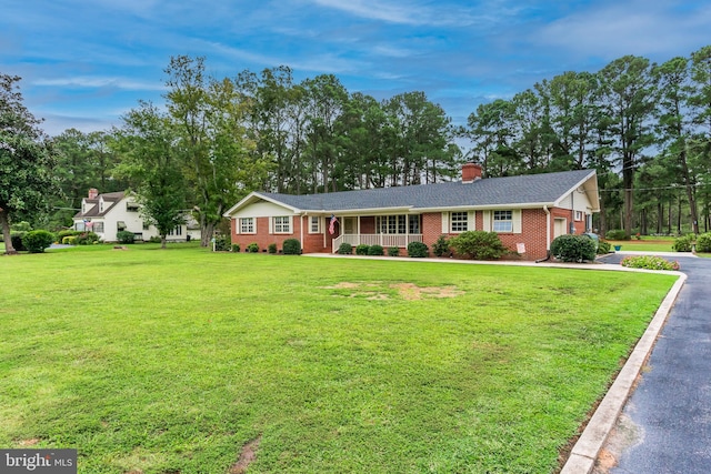 single story home with a front yard and a porch