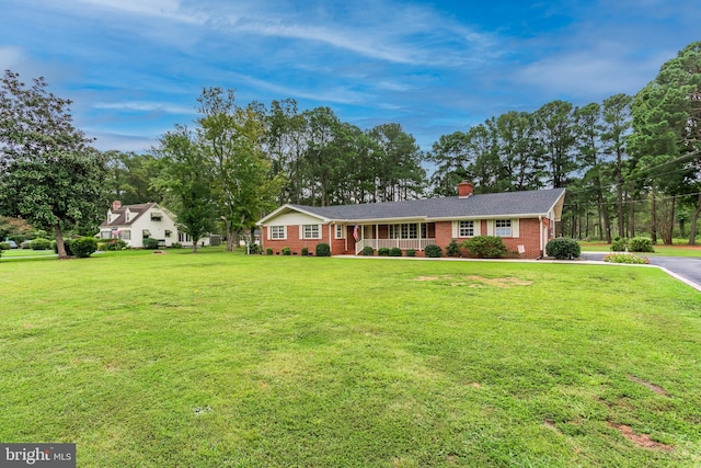 single story home with a porch and a front yard