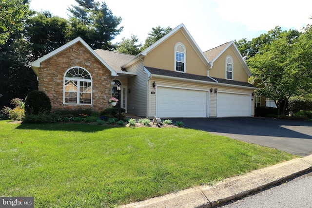 view of front facade with a front yard and a garage