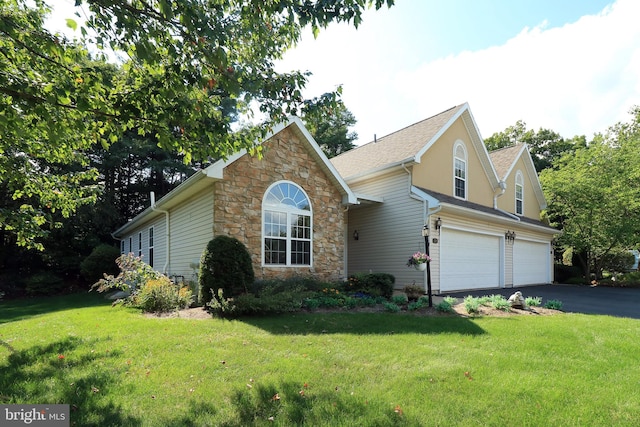 view of front facade with a garage and a front lawn