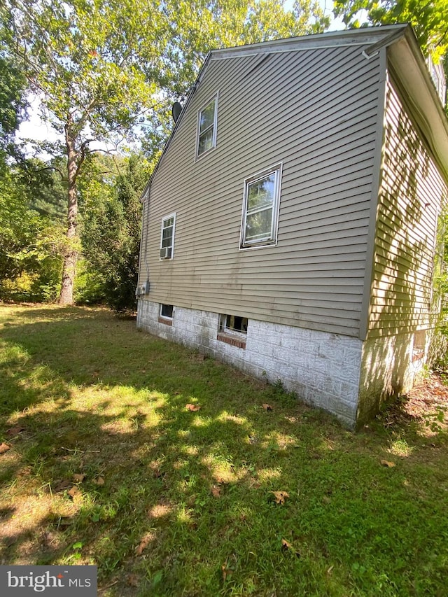 view of side of home with a lawn