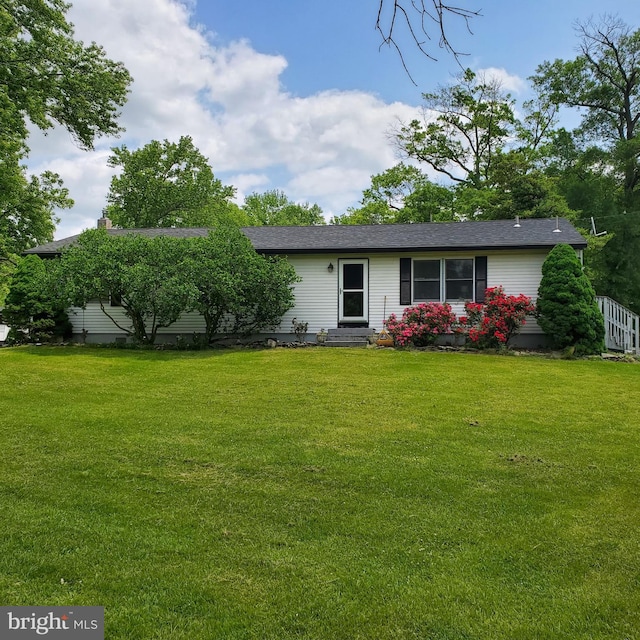 rear view of house with a yard