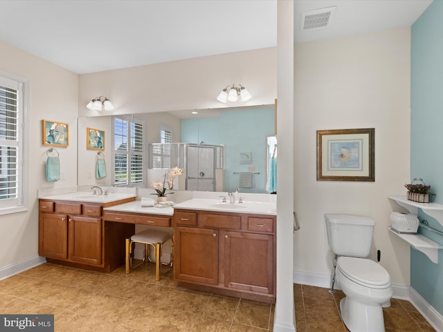 bathroom featuring vanity, an enclosed shower, and toilet