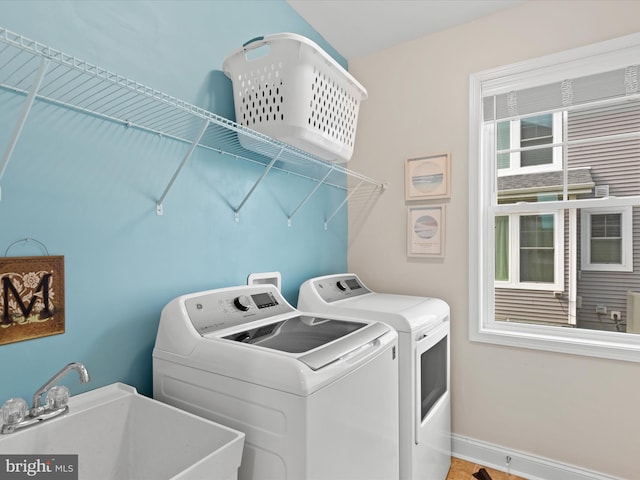 laundry room with independent washer and dryer and sink