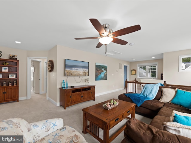 carpeted living room featuring ceiling fan