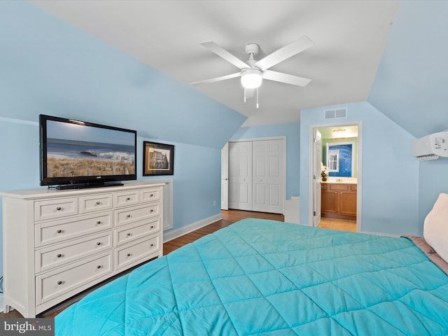 bedroom featuring a closet, light hardwood / wood-style floors, vaulted ceiling, ensuite bathroom, and ceiling fan