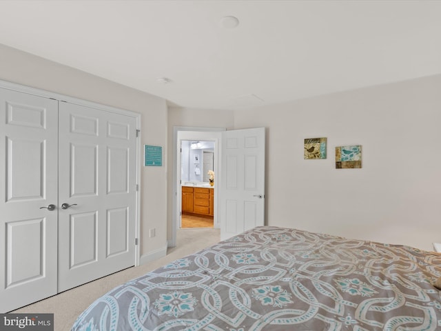 bedroom featuring light colored carpet and a closet