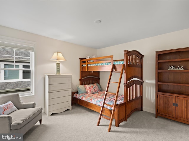 bedroom featuring light carpet