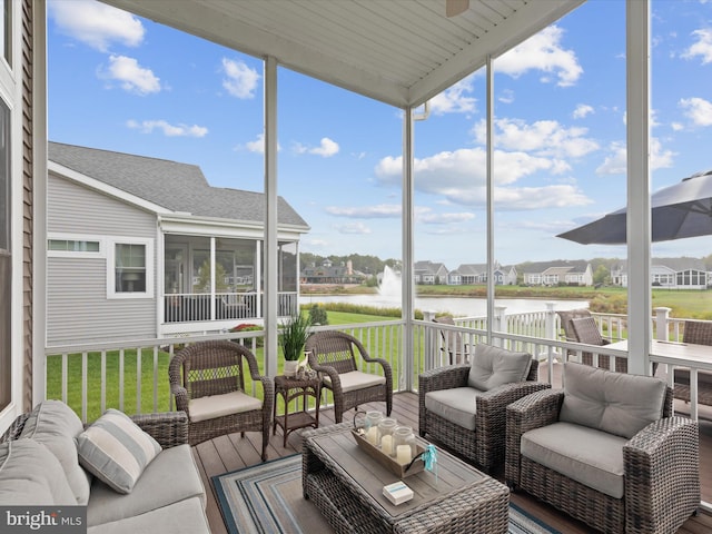 sunroom featuring a healthy amount of sunlight and a water view