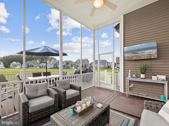 sunroom with ceiling fan and wood ceiling