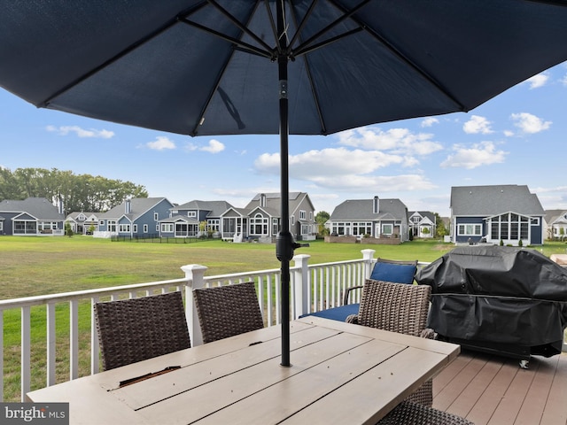 wooden terrace featuring a lawn and area for grilling