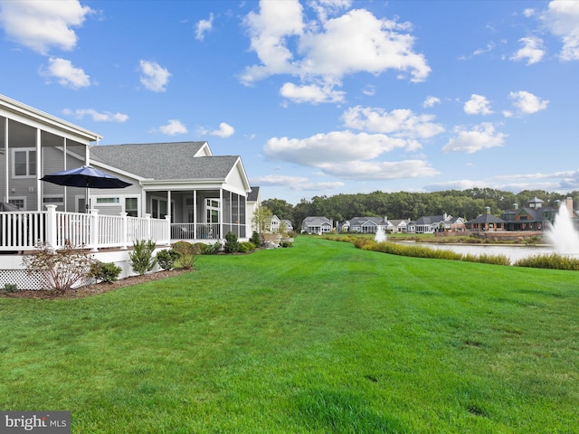 view of yard with a sunroom and a deck