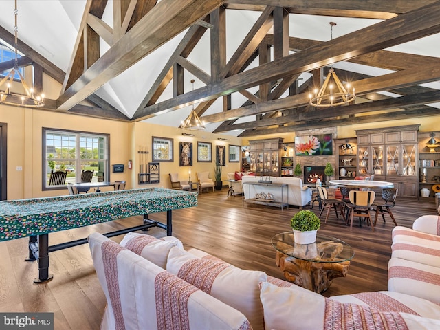 living room with a notable chandelier, beam ceiling, high vaulted ceiling, and hardwood / wood-style floors