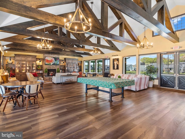 recreation room with high vaulted ceiling, a wealth of natural light, and a chandelier