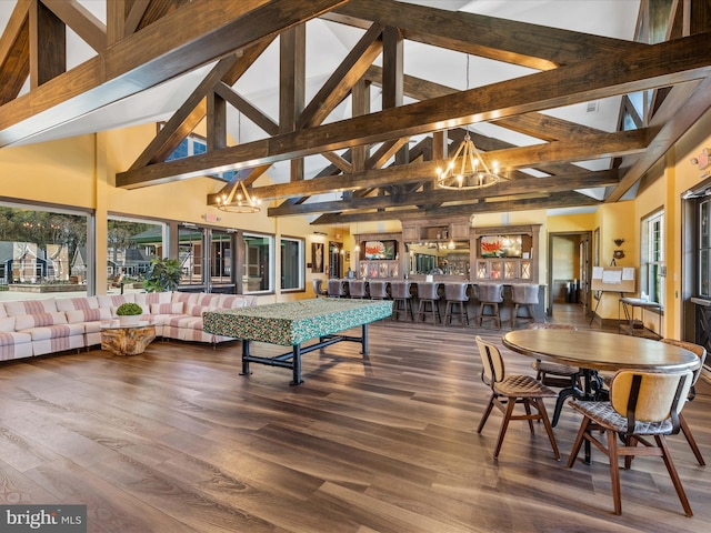 dining room featuring high vaulted ceiling, beam ceiling, a chandelier, and hardwood / wood-style floors