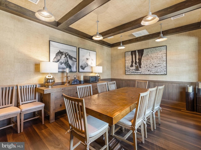 dining room with beam ceiling and dark hardwood / wood-style flooring