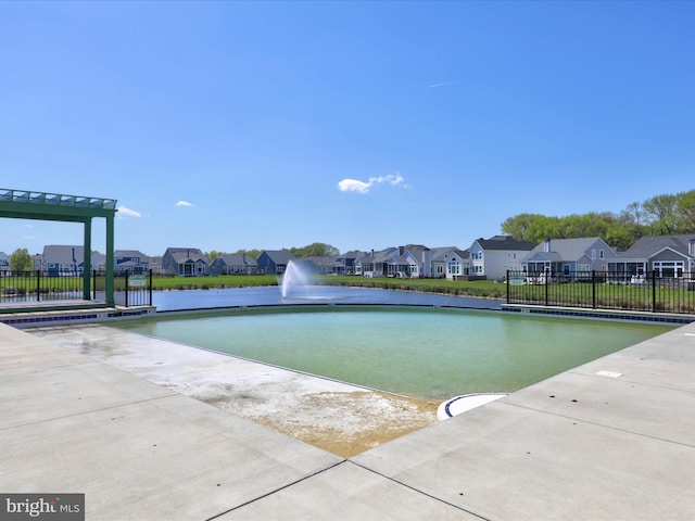 view of swimming pool with a water view and a yard