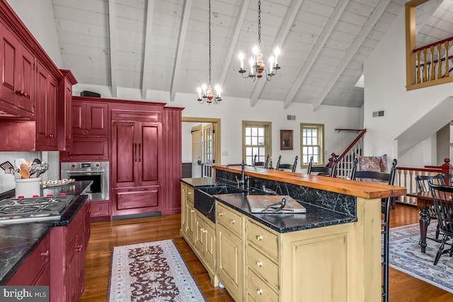 kitchen with a kitchen island, stainless steel appliances, cream cabinets, and dark hardwood / wood-style flooring