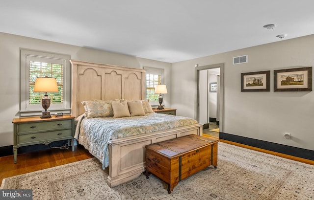 bedroom with dark hardwood / wood-style floors