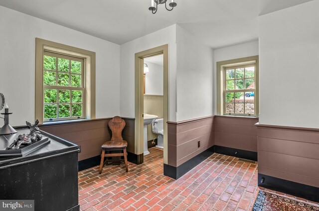 clothes washing area featuring cabinets, sink, and washing machine and clothes dryer