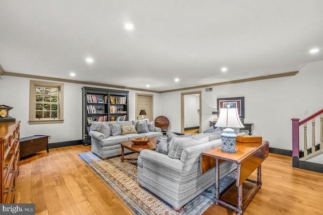 living room featuring ornamental molding and light wood-type flooring