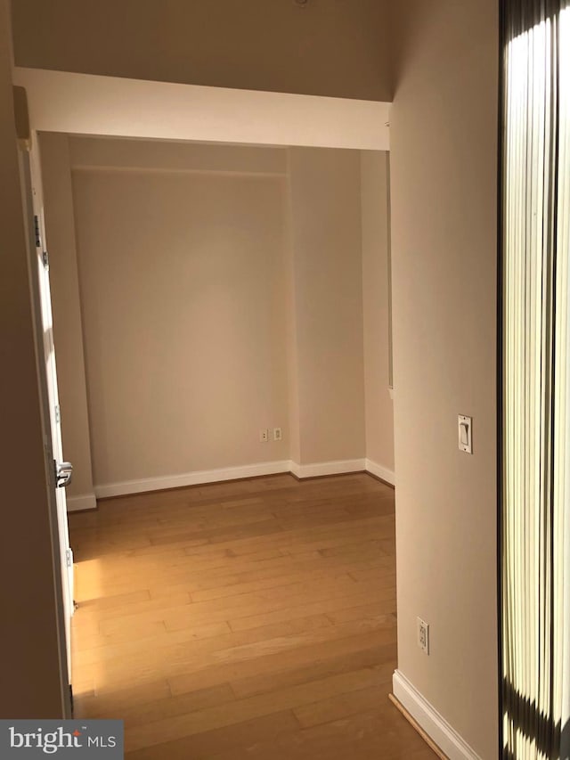 empty room with wood finished floors and baseboards