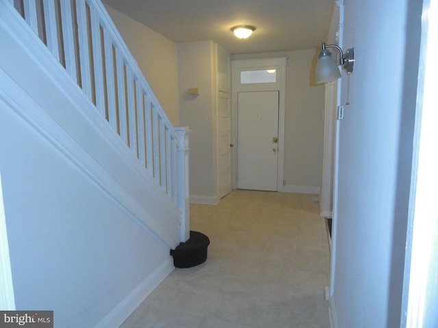 entryway with baseboards and stairs