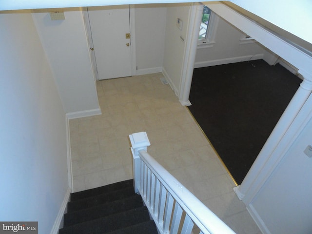 staircase featuring tile patterned flooring