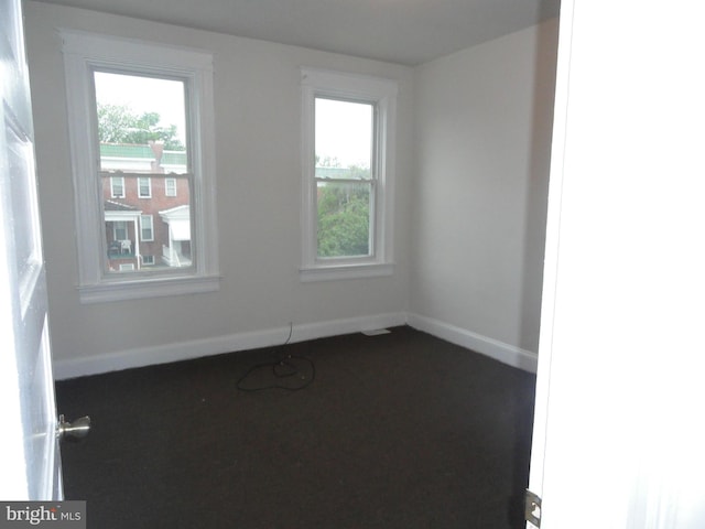 unfurnished room featuring plenty of natural light