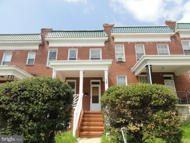 view of property with cooling unit and a porch