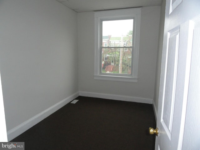 empty room featuring baseboards
