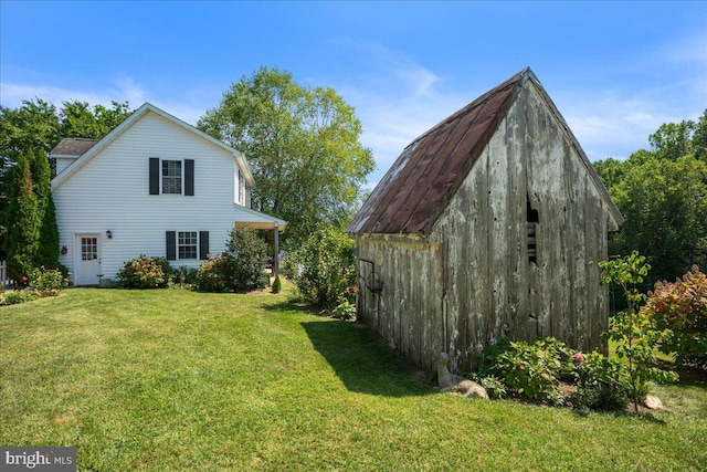 exterior space with an outdoor structure and a yard