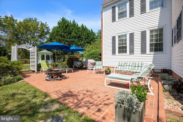 view of patio featuring a pergola and an outdoor living space with a fire pit