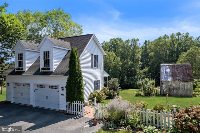 view of home's exterior featuring a lawn and a garage