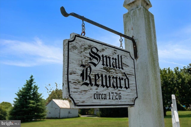 community / neighborhood sign with a lawn