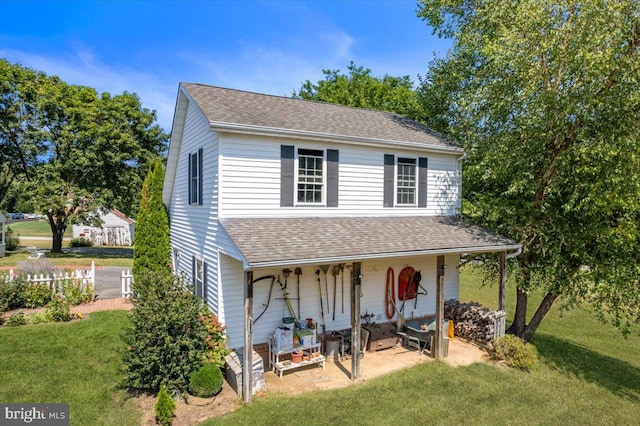 view of front of house with covered porch and a front yard