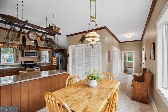 tiled dining room featuring a notable chandelier, crown molding, and sink