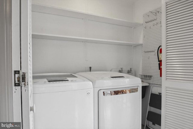 washroom with washing machine and clothes dryer