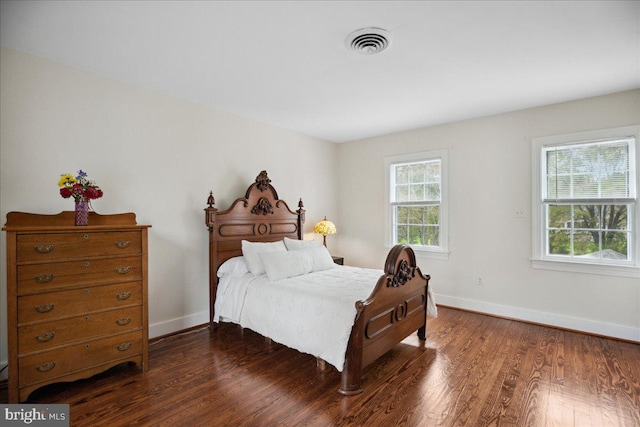 bedroom with dark hardwood / wood-style floors