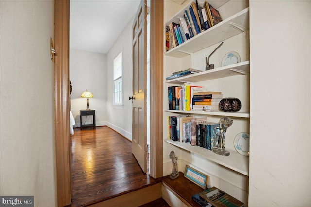 corridor with wood-type flooring