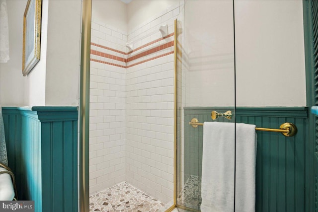 bathroom featuring a shower with door