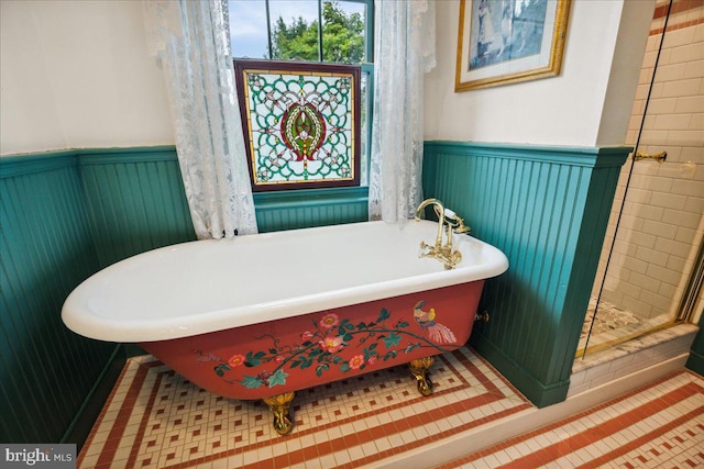 bathroom featuring tile patterned flooring and separate shower and tub