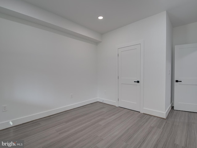 spare room with light hardwood / wood-style flooring