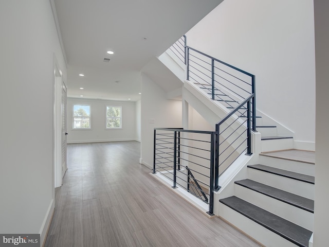 staircase featuring wood-type flooring